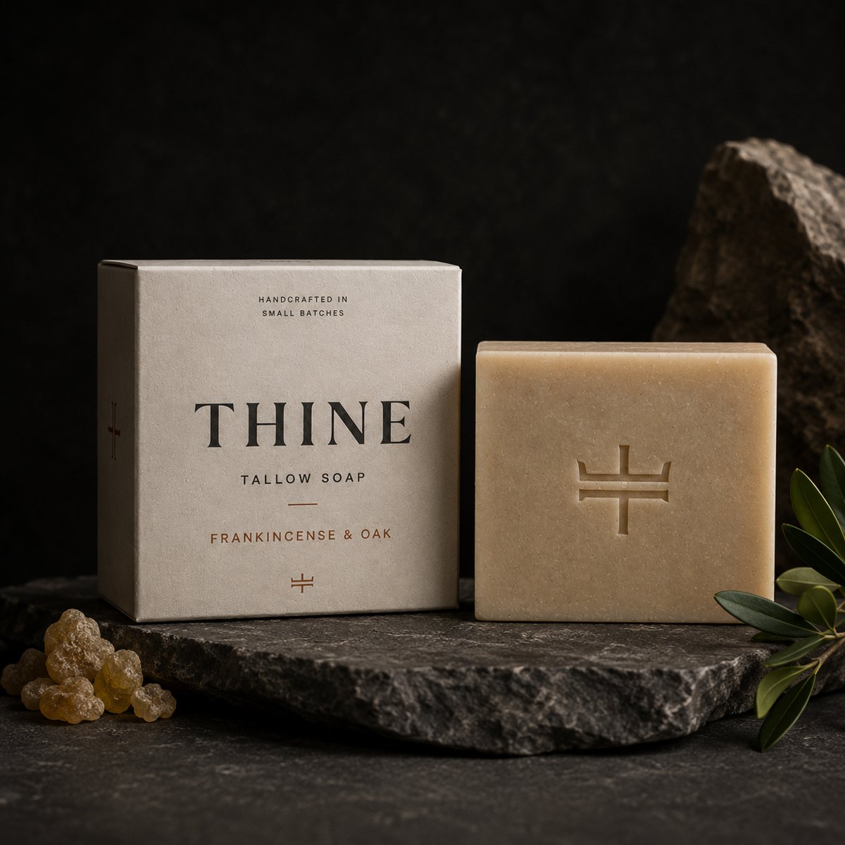 THINE Frankincense & Oak bone-colored soap box beside an unwrapped tallow bar.